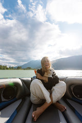 Woman enjoying a boat ride with her dog, powered by Sunii Energy Gum